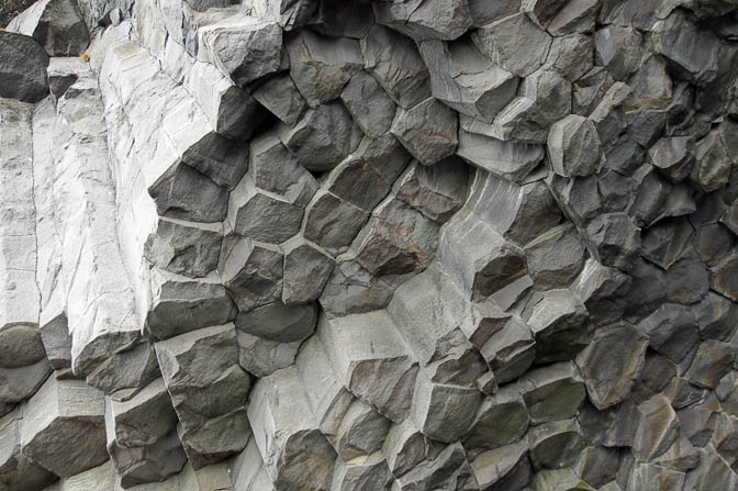 Basalt geometrical column rock formations on the black sand volcanic Kirkjufjara beach near Vik, 2012