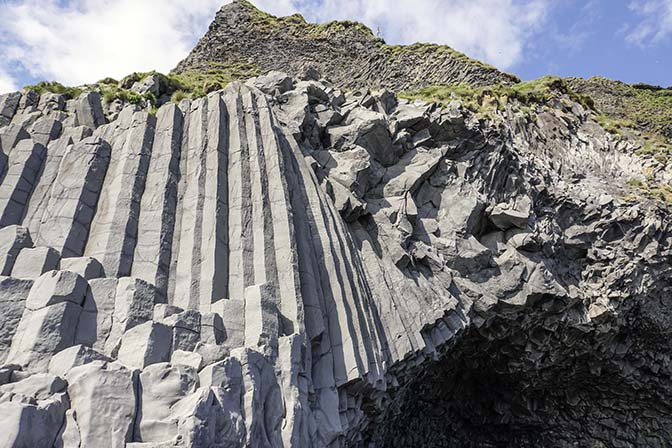 Basalt column rock formations on the black sand volcanic Kirkjufjara beach near Vik, 2017