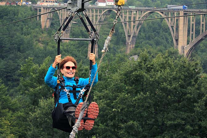 I am gliding down a Zipline above the Tara Canyon against the Djurdjevich Bridge, 2019