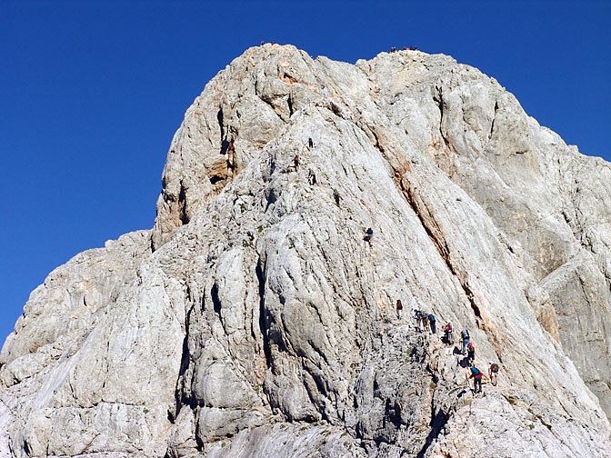 A line of climbers meticulously moving up the Triglav soaring peak, 2007