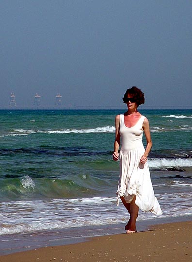 A woman walking on the beach north of Herzeliya, The Israel National Trail 2003