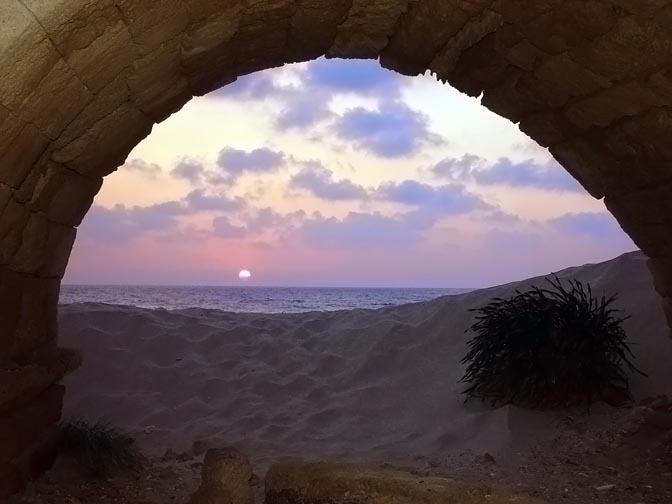 The sunset seen through the vaults of the Roman Aqueduct in Caesarea beach, The Israel National Trail 2002
