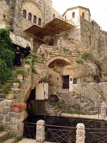 Catholic-Franciscan monk and nun descend to the baptisterium in The Monastery of St. John in the Wilderness, Even Sappir 2008