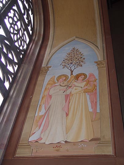 Mural of angels sing and play by a window decorated with palms and palmettos in The Church of the Visitation, Catholic-Franciscan Fathers, 2008
