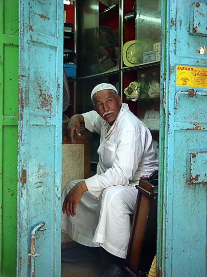 An Arab merchant in the entrance of a small shop in the market, The Old City 2003