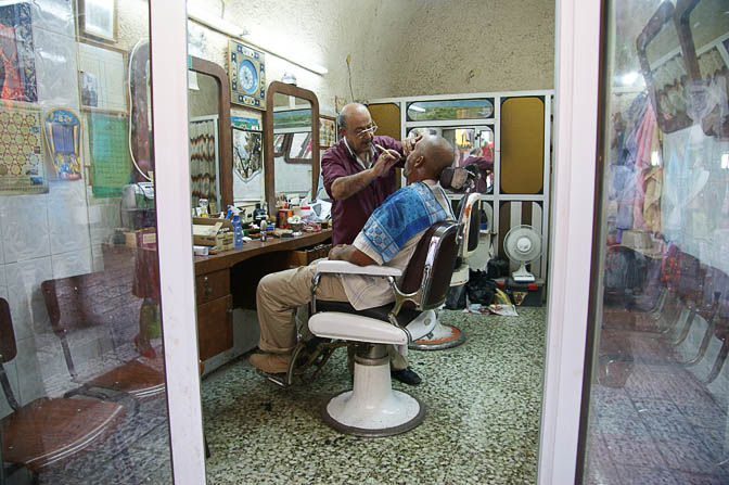 A barber at work in Ha-Shalshelet street, The Old City 2008