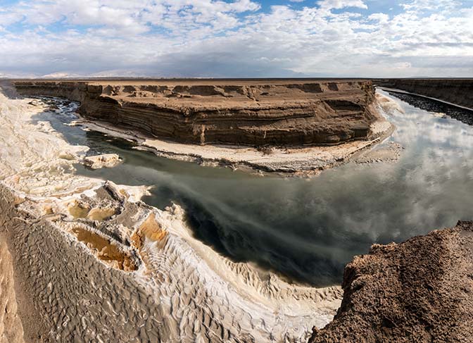 The Araba Stream, containing spring water, floodwaters, and salt water from the industrial evaporation ponds, flowing north to the Dead Sea, 2021