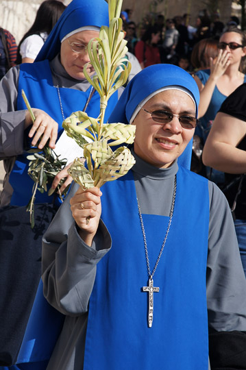 Franciscan nuns raising palm-made decorations in the procession, Mount of Olives 2012
