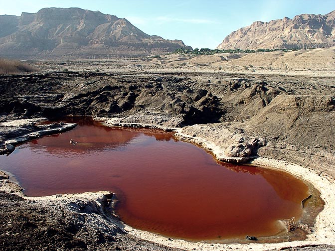 A sinkhole filled with dark red water, Ein Gedi coast 2003
