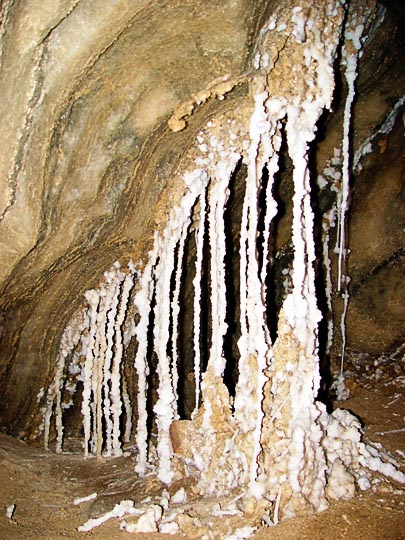White salt stalactites and stalagmites glitter in the darkness inside the Colonel cave, Mount Sodom 2002