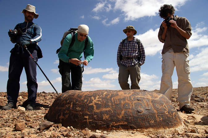 Hug Elad members admire prehistoric rock drawings on Mount Karkom, the desert of Paran 2009