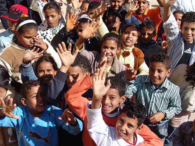 School kids waving for welcome while visiting The Mortuary Temple of Ramesses III at Medinet Habu, 2006