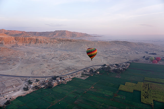 The clear-cut between the green fertile Nile valley and the desert, from a baloon, above Valley of the Kings at Luxor's West Bank 2017