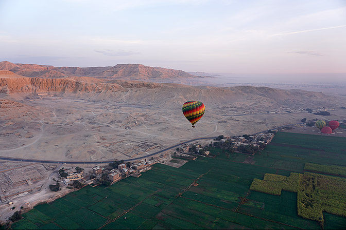 The clear-cut between the green fertile Nile valley and the desert, from a baloon, above Valley of the Kings at Luxor's West Bank 2017