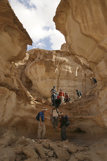 Down a sandstone waterfall in Wadi er Raqiya, 2011