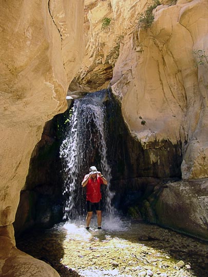 Ishai showers under a waterfall in Wadi el Karak, 2007
