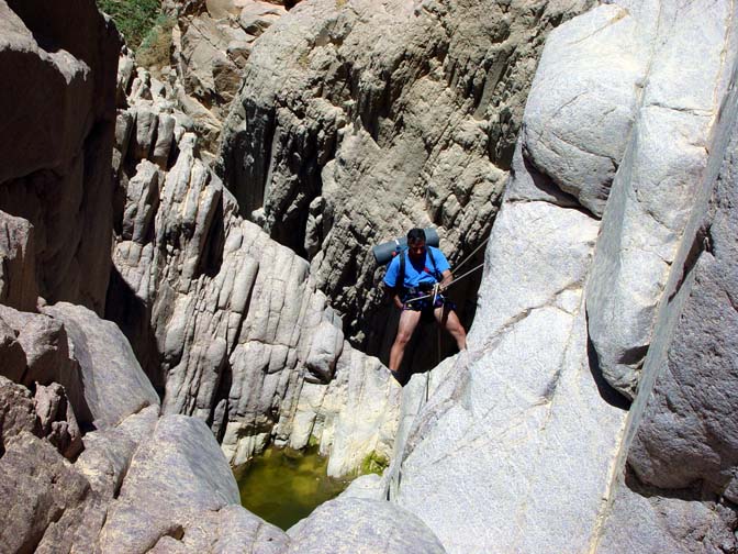 Ynon rappels (abseils) by a pool in Wadi Shamah, 2003