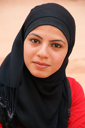 A young Muslim girl wearing a veil (Hijab) by Al Khazneh, 2009