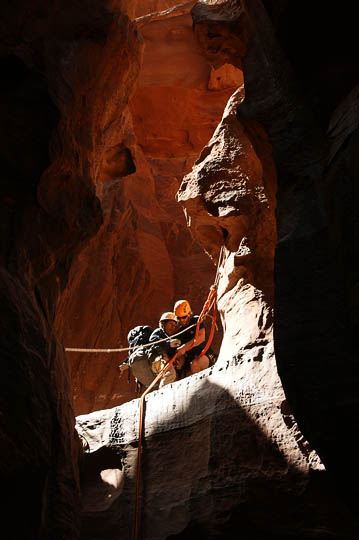 Nimrod secures Dorit in a rappelling (abseiling) station in the gorge of Jabel Khazali, 2009