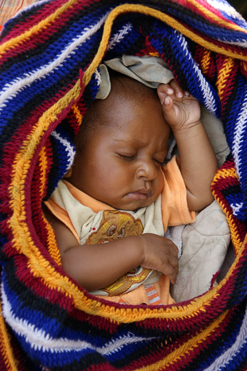 A baby in a knitted Bilum (string bag), Polga 2009