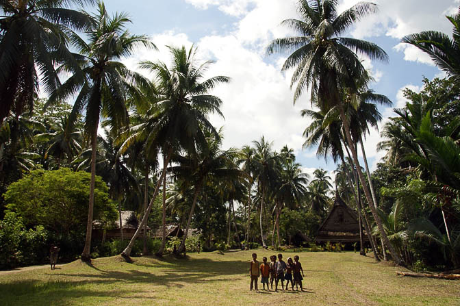 Kids in front of a Haus Tambaran (Spirit House) in Yamok, the Sepik River 2009