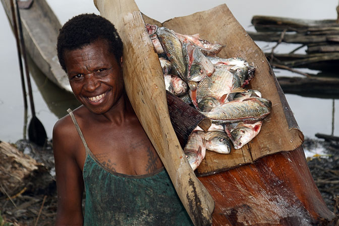 A canoe-fisherwoman from Kararau carries her catch-of-the-day, the Sepik River 2009