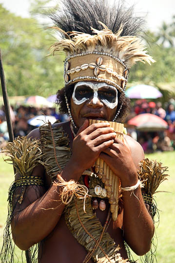 A young man from the West New Britain Province, playing a bamboo flute at The Wewak Garamut and Mambu Festival 2009
