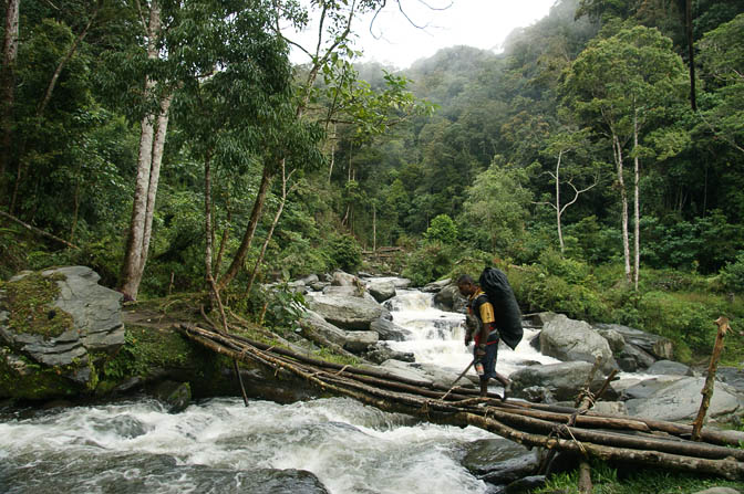 My personal porter Rommy crosses a creek, The Kokoda Trek 2009