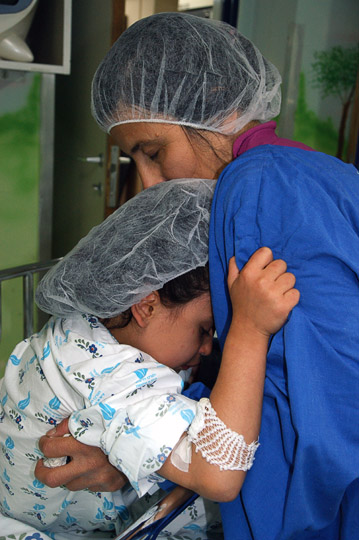 Hawraz from Iraqi Kurdistan hugs her mom goodbye in the surgery preparation room, The Wolfson Hospital 2011
