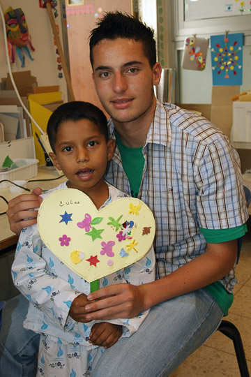 Adnan from Gaza and a volunteer in the games room, The Wolfson Hospital 2011